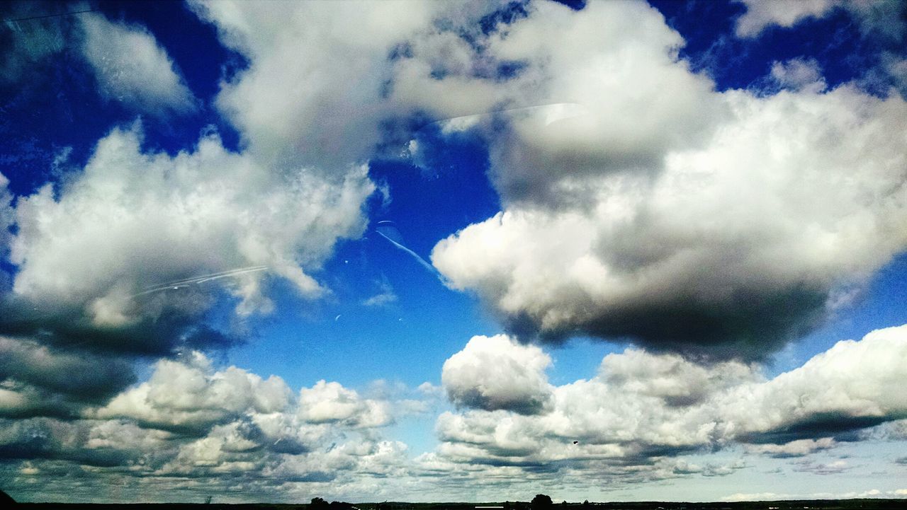 Low angle view of cumulus clouds in blue sky