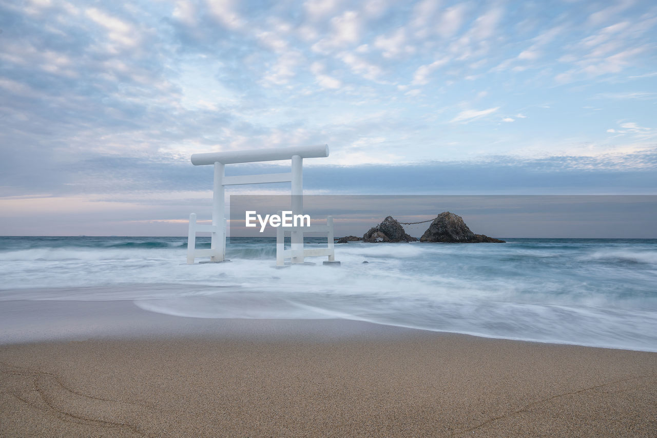 LIFEGUARD HUT ON SEA SHORE AGAINST SKY