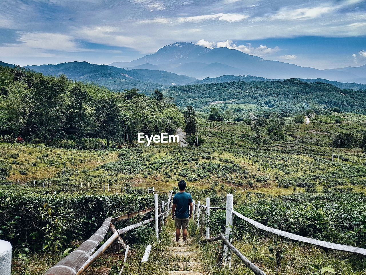 High angle view of man standing on steps against mountains