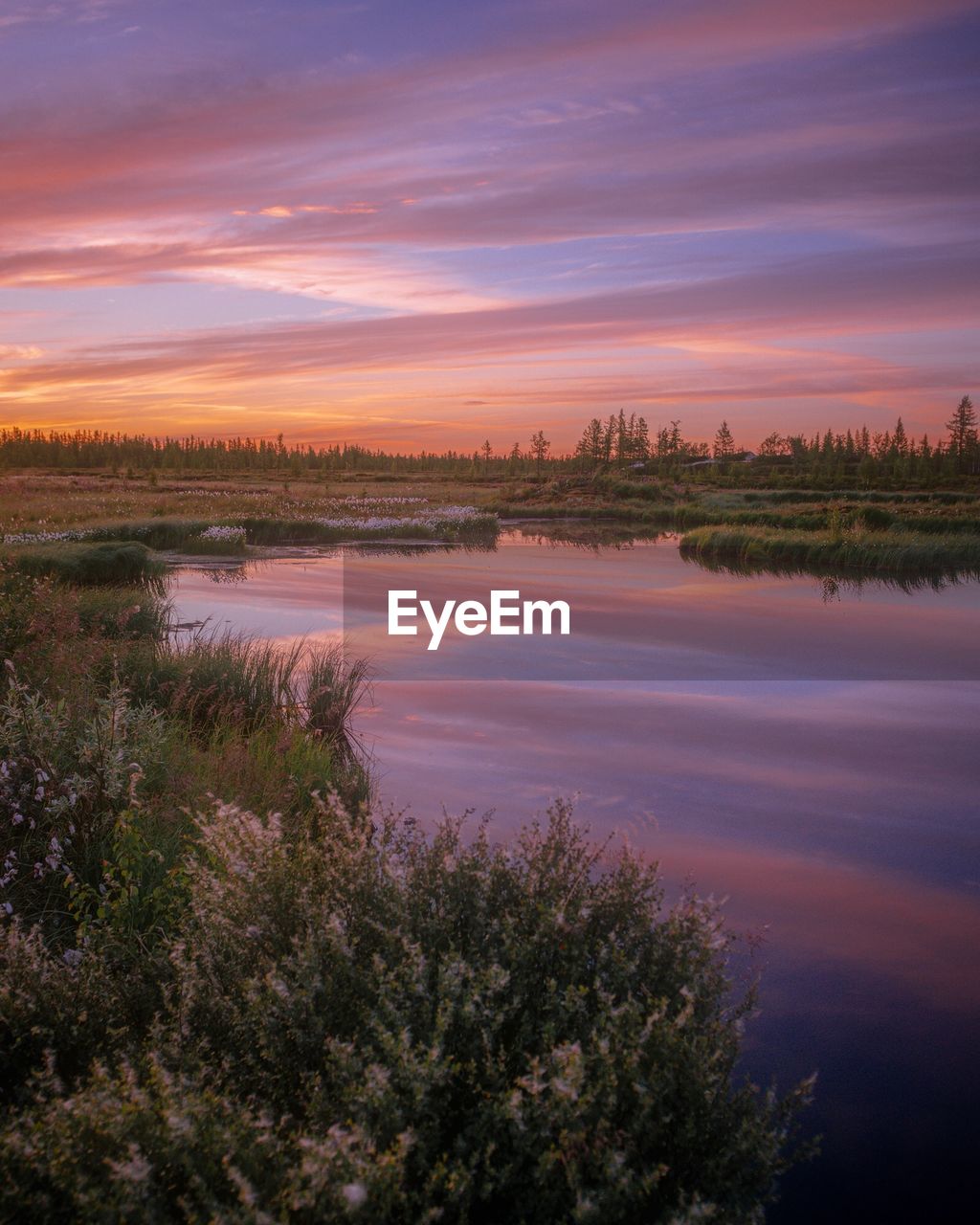 Scenic view of lake against sky during sunset