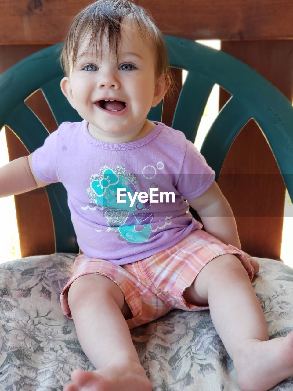 Portrait of cute baby girl sitting at home