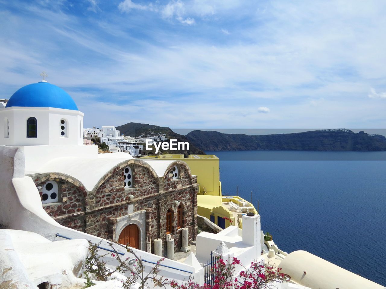 House by sea with mountains on background