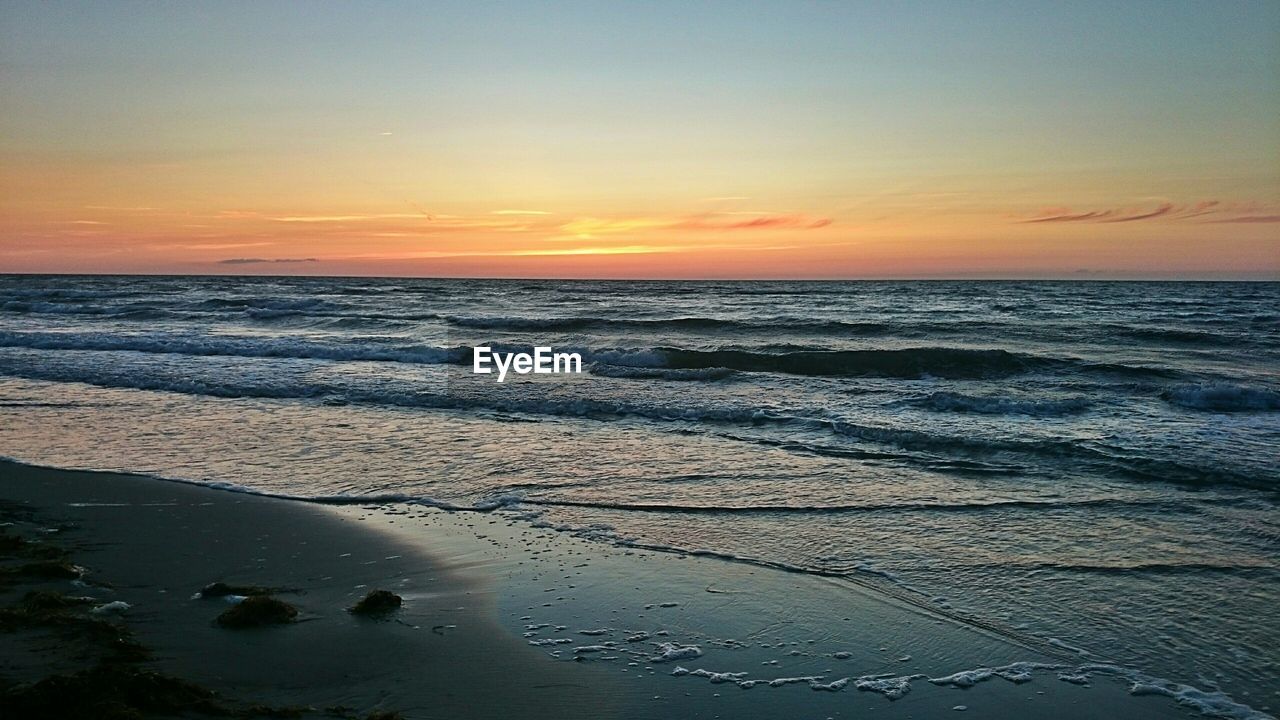 Scenic view of sea against sky at sunset