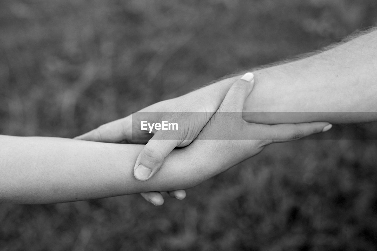 Close-up of bride and groom with holding hands