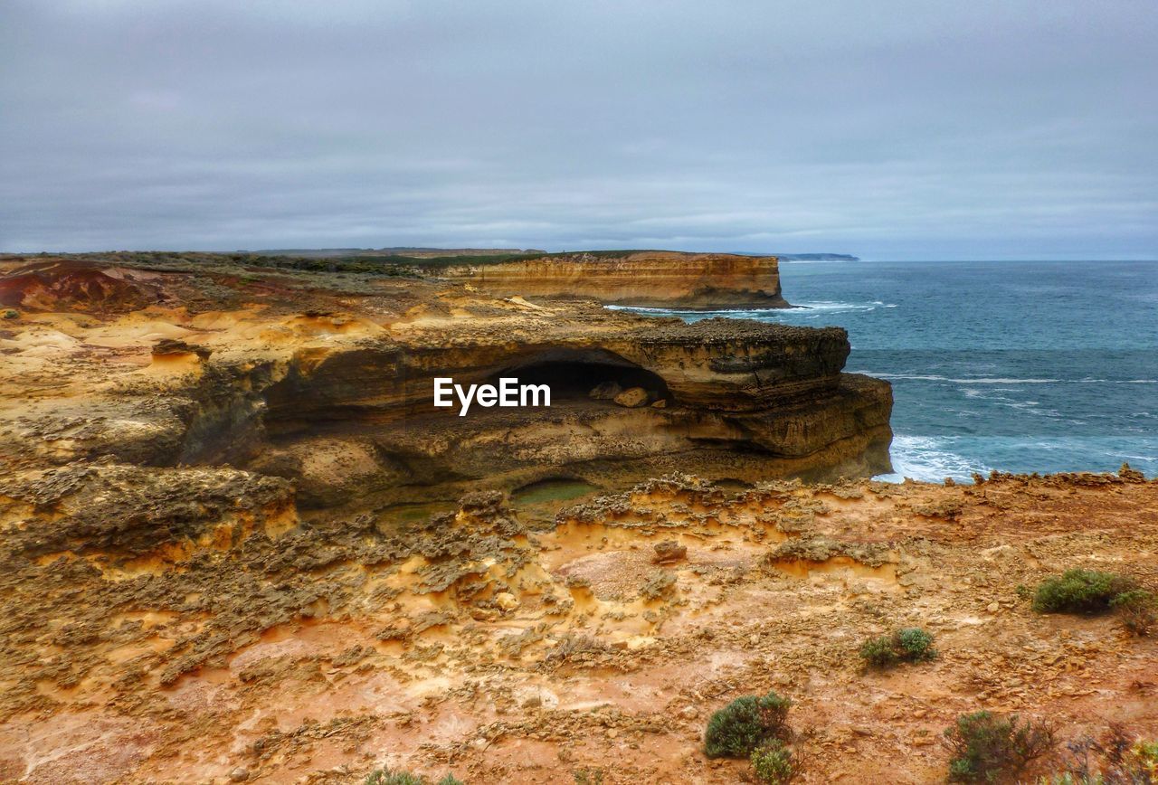 SCENIC VIEW OF SEA WITH ROCKS IN BACKGROUND