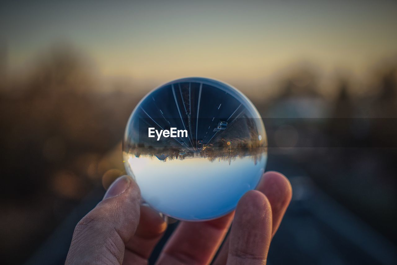 Cropped hand of person holding crystal ball