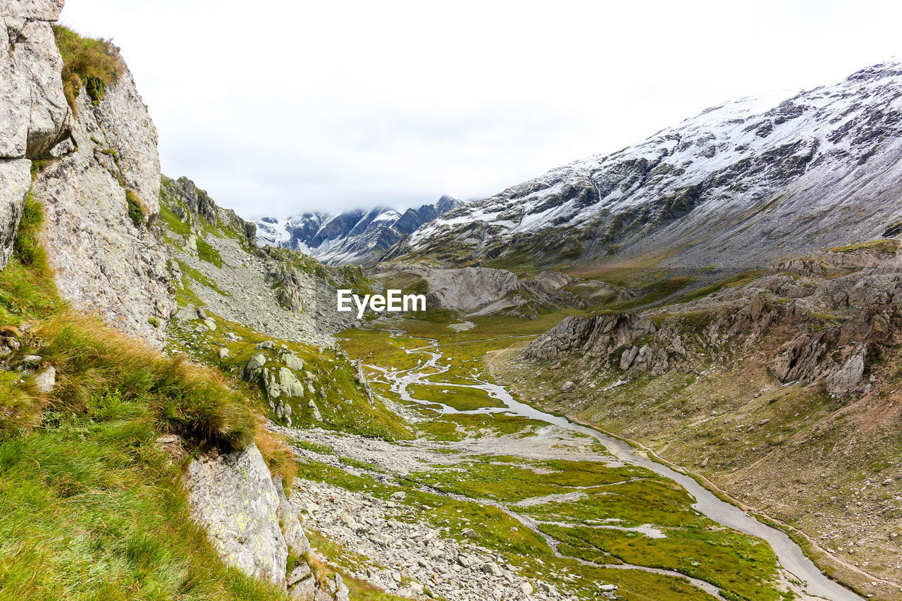 Greina high plateau with stream in swiss alps