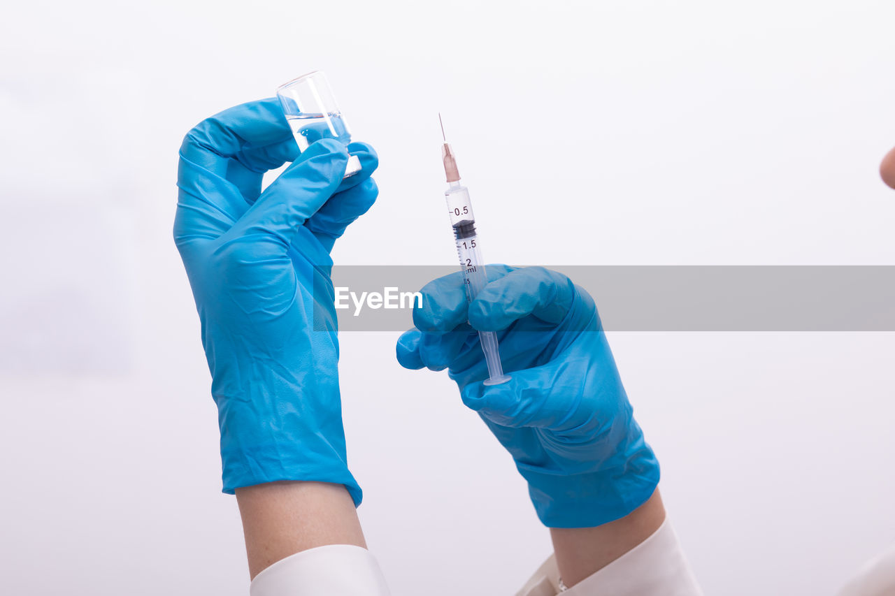 Doctor holding syringe and medicine in hospital