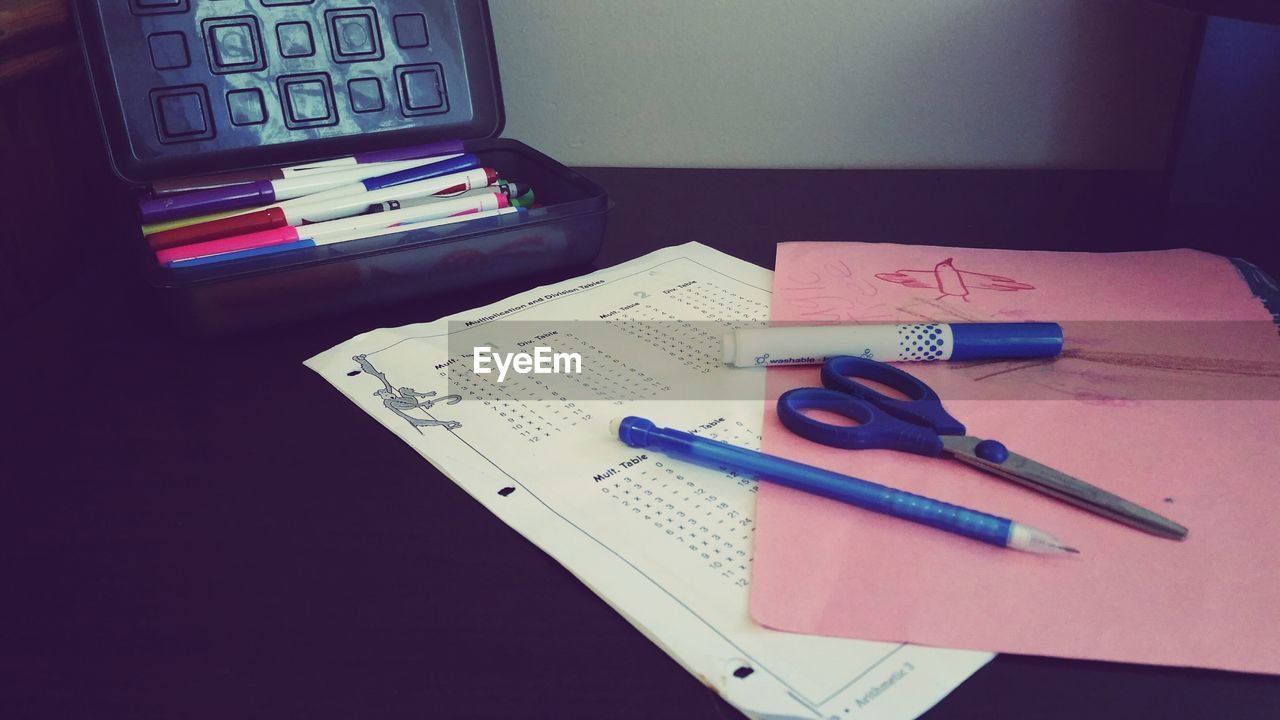 High angle view of school supplies on table