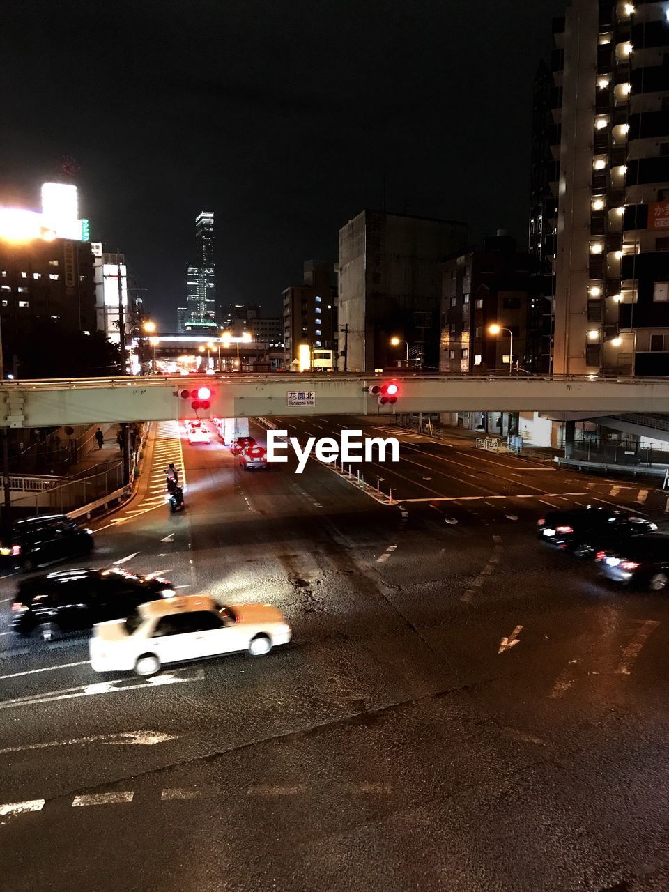 CARS ON ILLUMINATED ROAD AT NIGHT