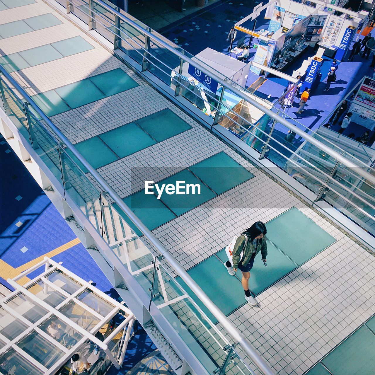 High angle view of woman walking on footbridge