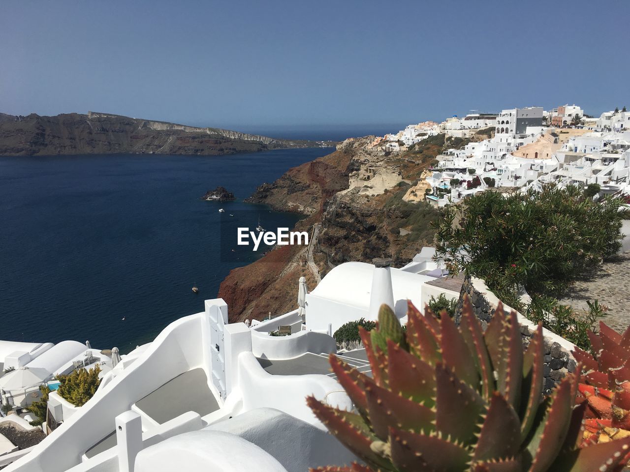 High angle view of townscape by sea against sky