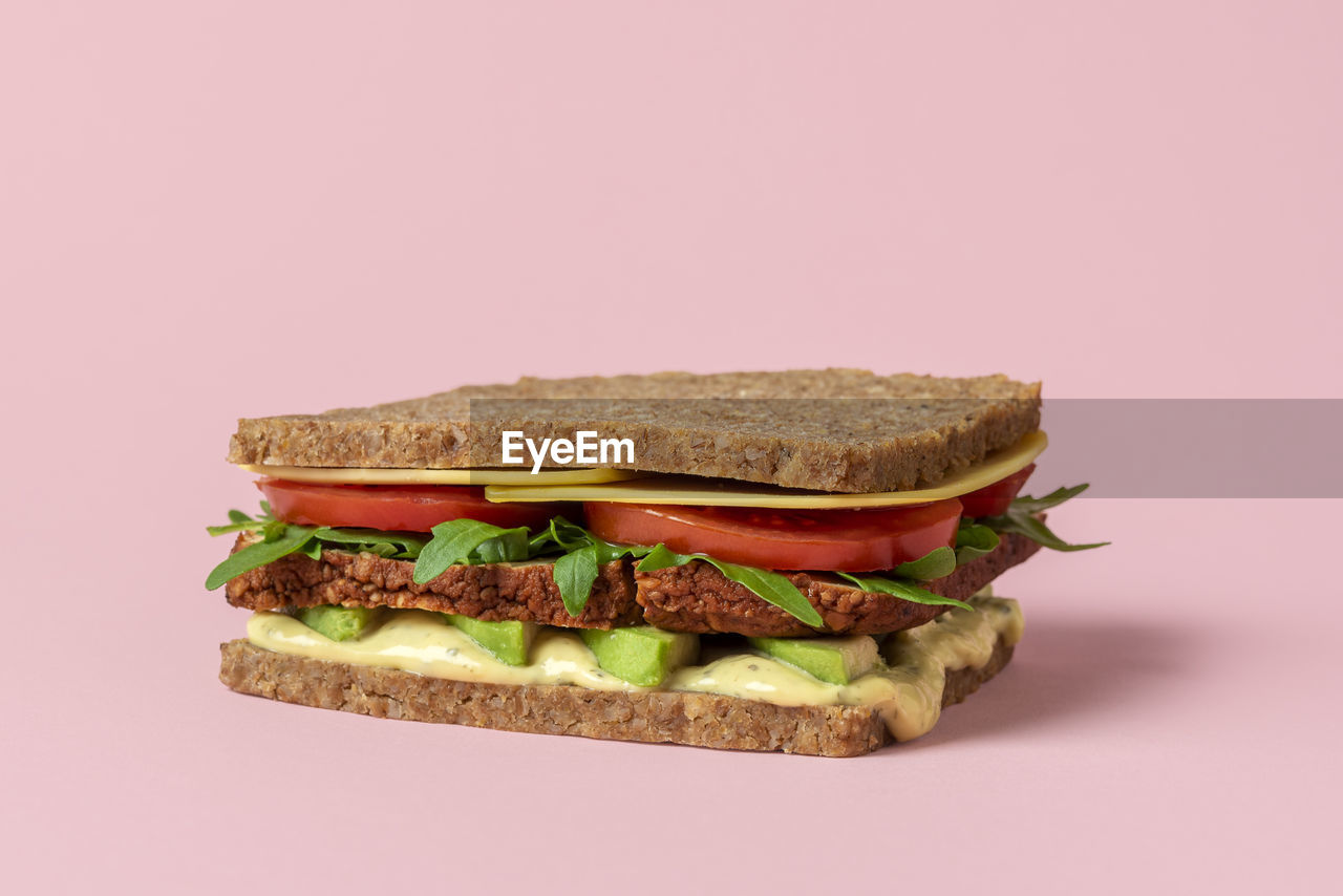 Healthy meatless sandwich with vegan ingredients and fresh vegetables. plant-based sandwich.