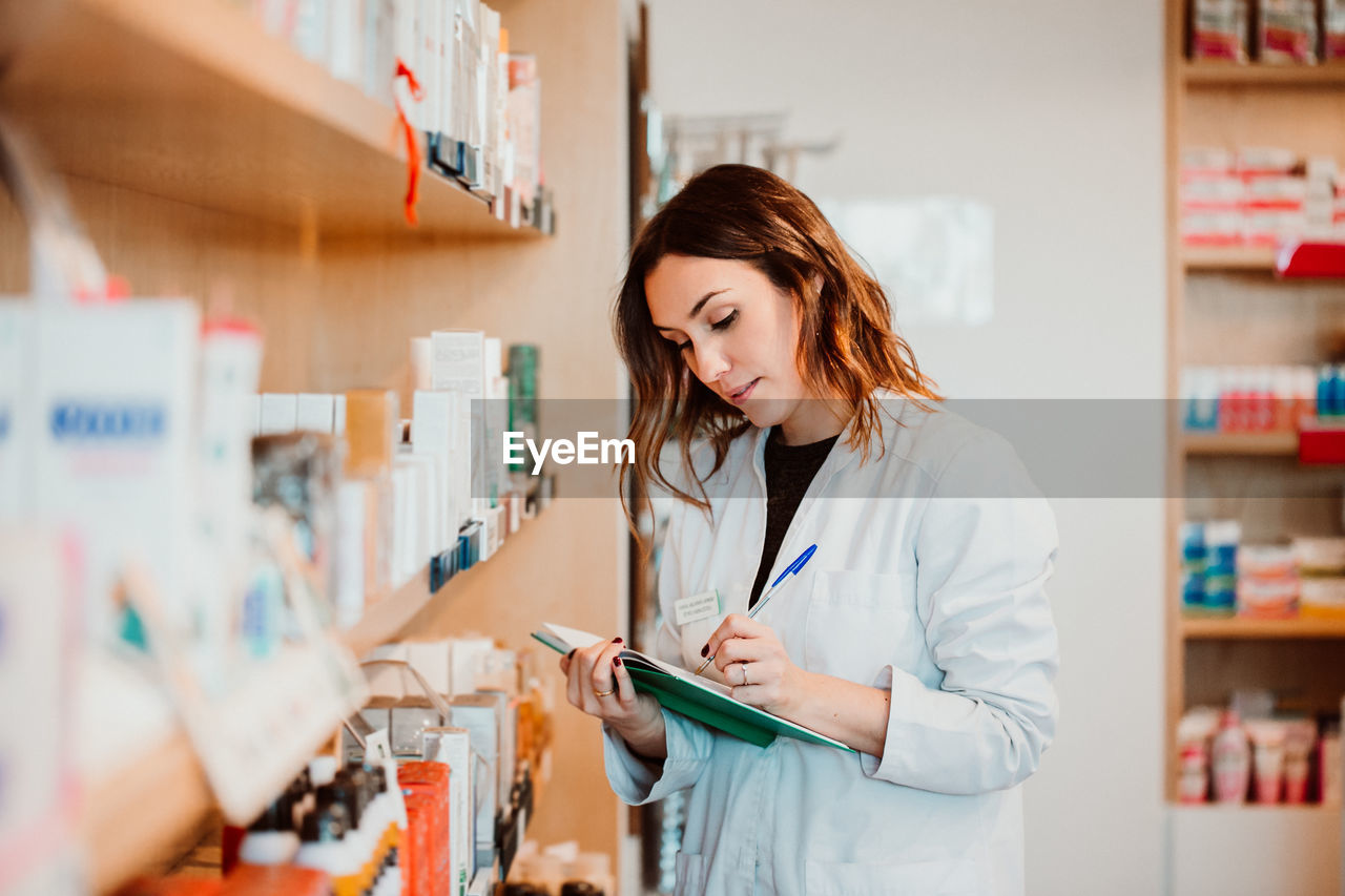 Female pharmacist working at store