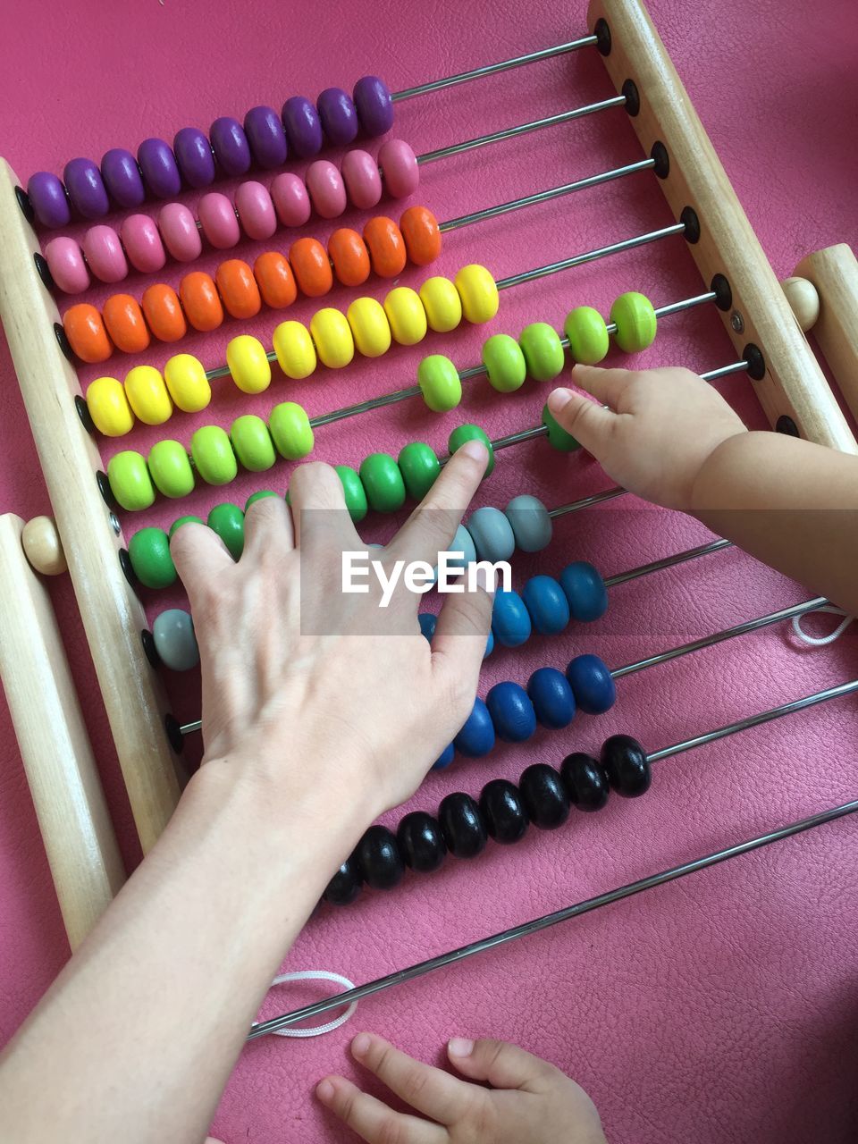 Cropped image of mother playing with kid at home