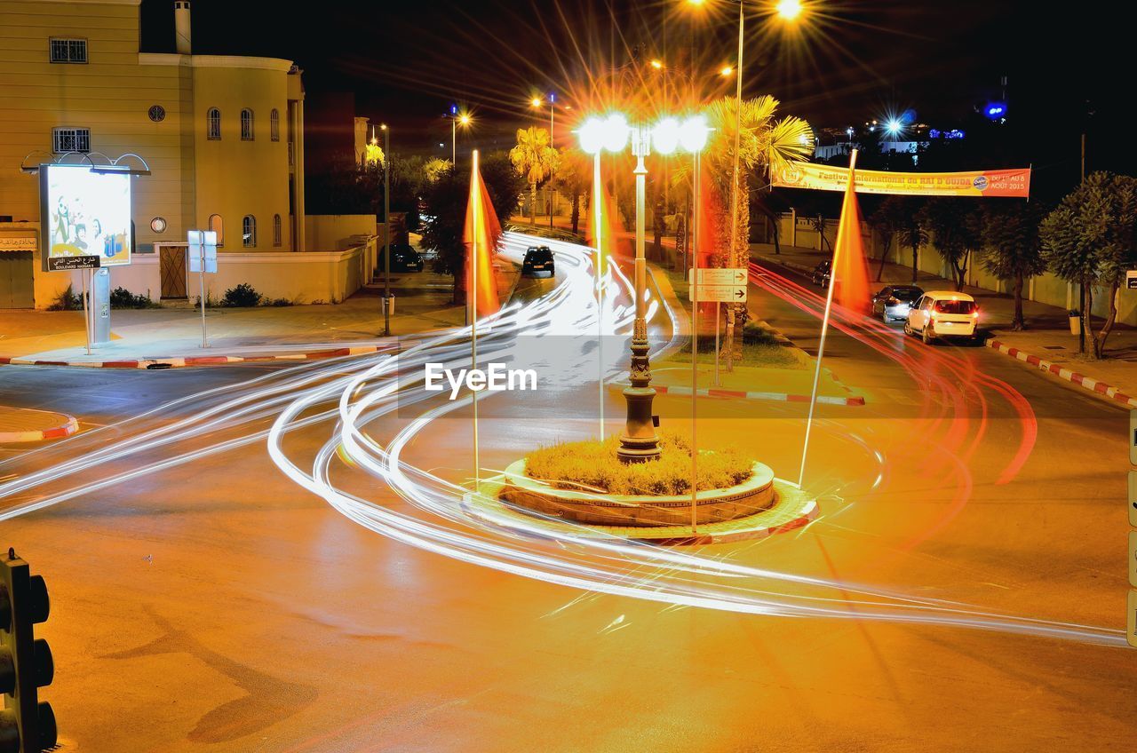 TRAFFIC LIGHT TRAILS ON ROAD AT NIGHT