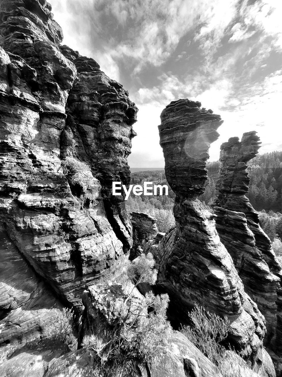 rock, rock formation, sky, cloud, nature, beauty in nature, scenics - nature, black and white, non-urban scene, mountain, monochrome photography, geology, no people, tranquility, day, land, physical geography, outdoors, tranquil scene, environment, landscape, monochrome, eroded, travel destinations, low angle view, travel, remote, cliff, mountain range, extreme terrain