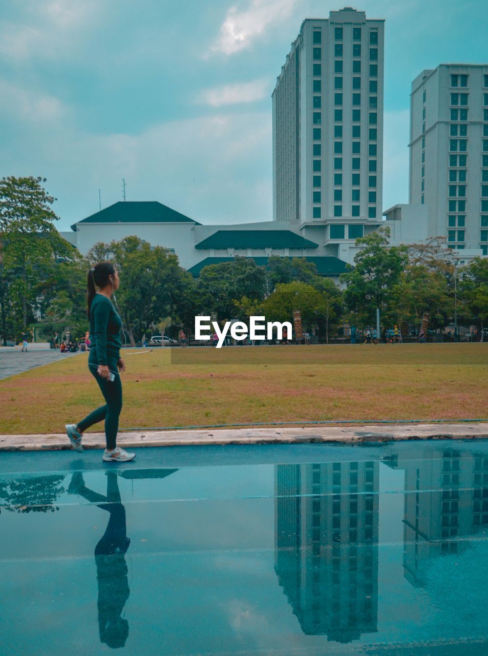 Woman walking by swimming pool