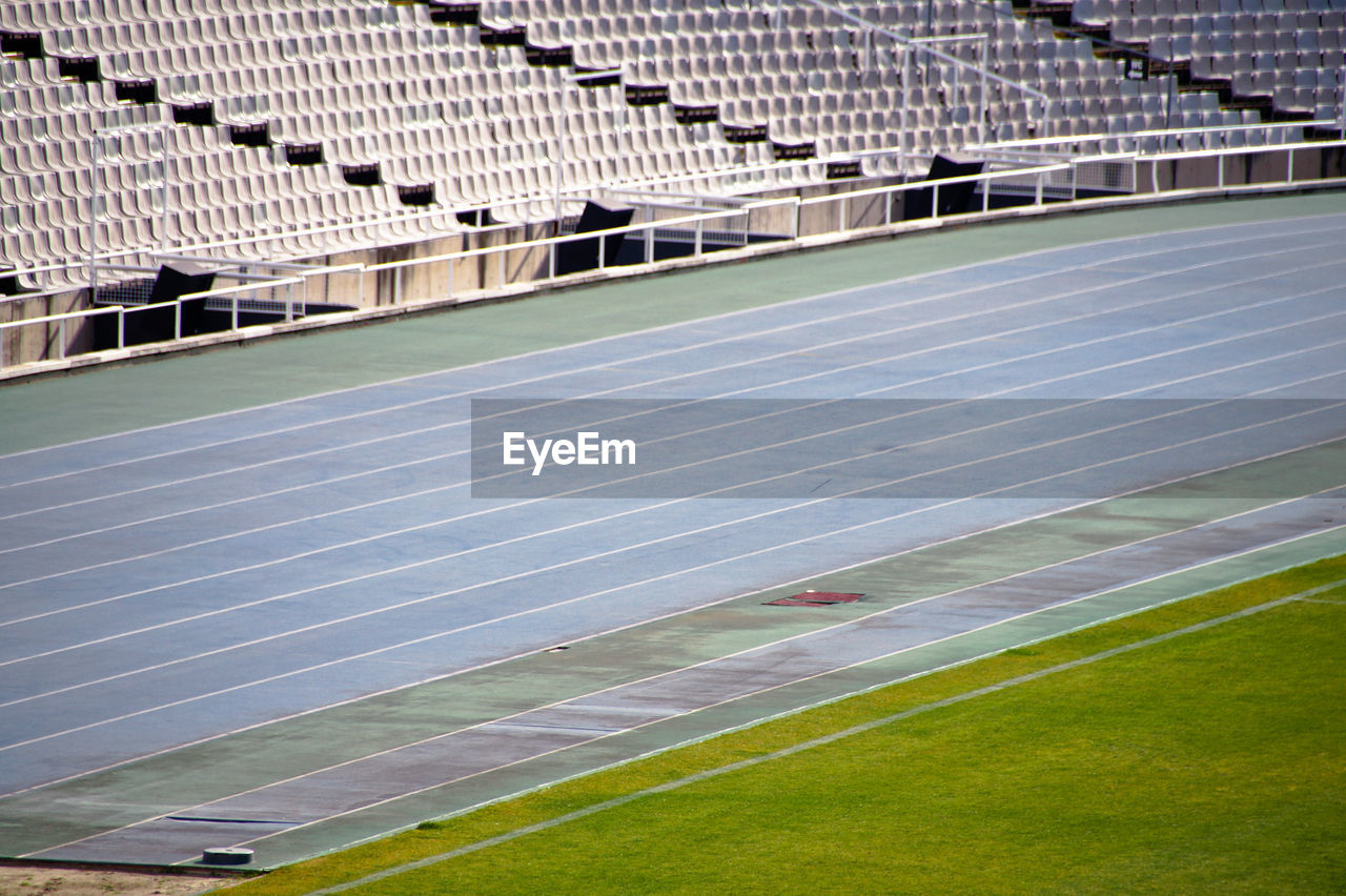 Scenic view of empty running track in stadium while corona