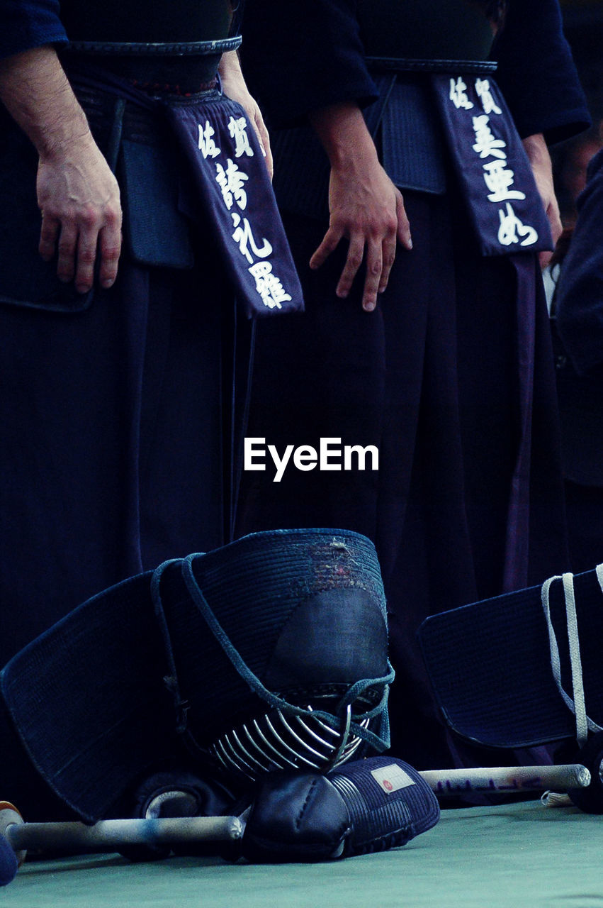 Low section of kendo players standing on floor