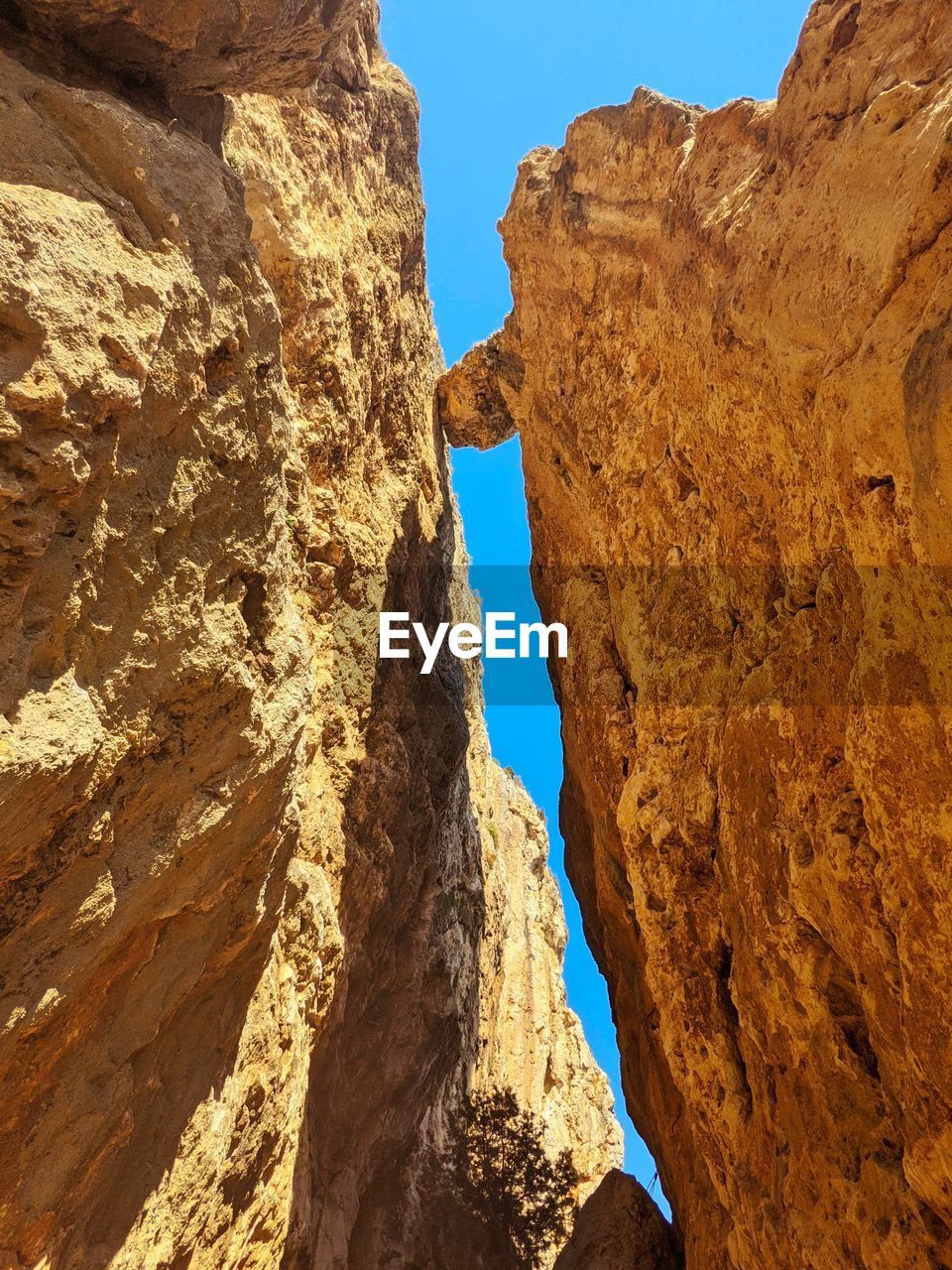 rock, rock formation, nature, wadi, travel destinations, scenics - nature, sky, formation, geology, arch, beauty in nature, travel, canyon, land, no people, cliff, non-urban scene, landscape, sunlight, terrain, day, clear sky, environment, mountain, blue, outdoors, tranquility, physical geography, sunny, desert, eroded, extreme terrain, tourism, valley, natural arch, tranquil scene, climate, low angle view, mountain range, sandstone