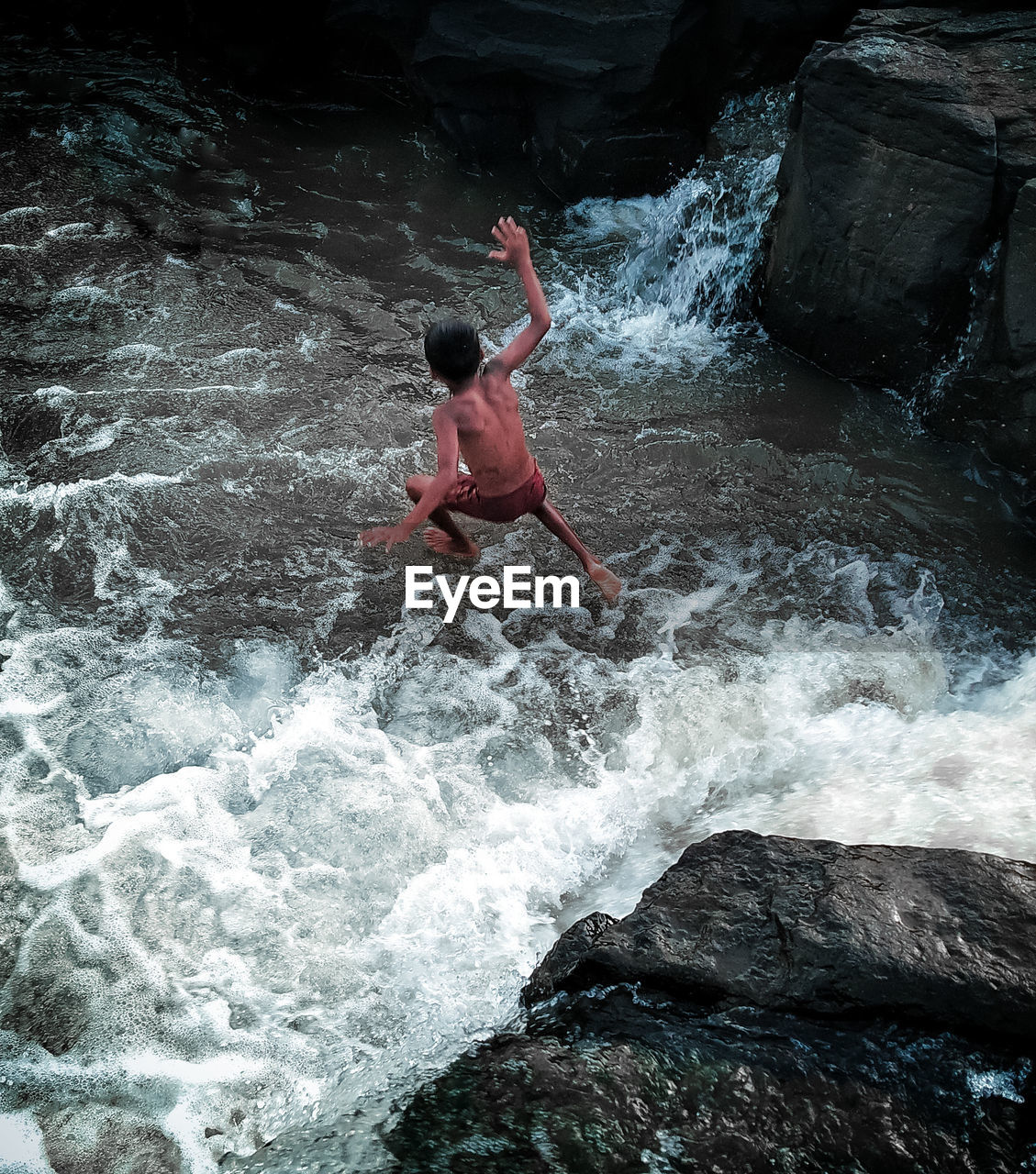 A boy jumping in the water