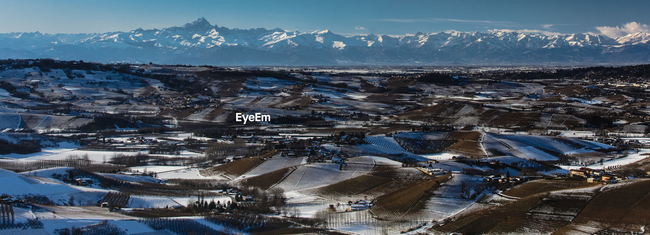 High angle view of snowcapped mountains against sky