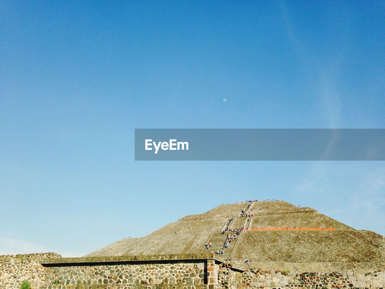 Tourists climbing pyramid of sun