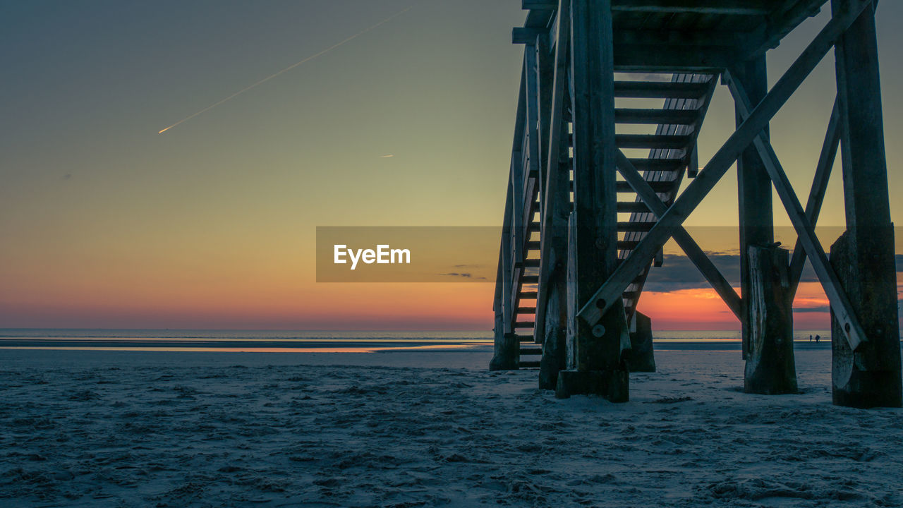 View of bridge over sea at sunset