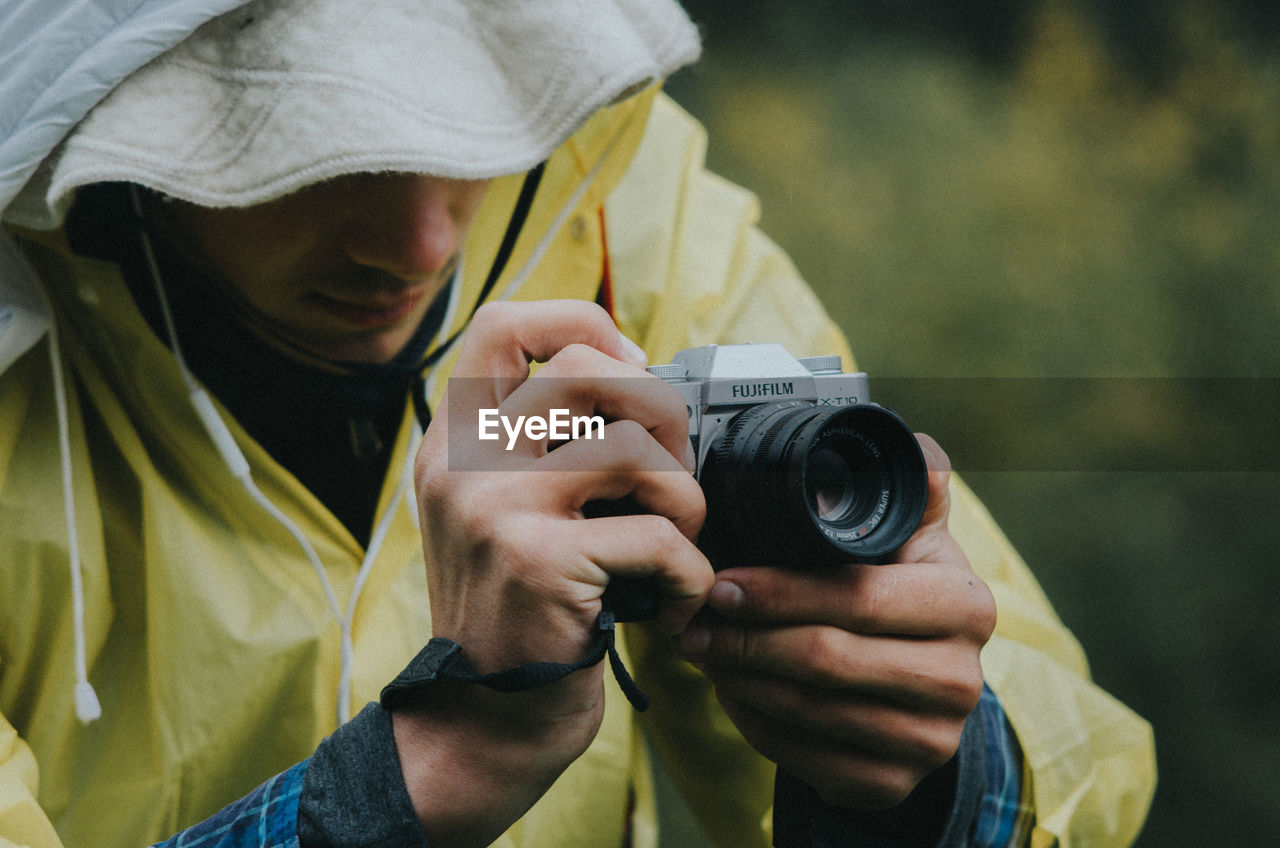 MAN PHOTOGRAPHING WITH CAMERA