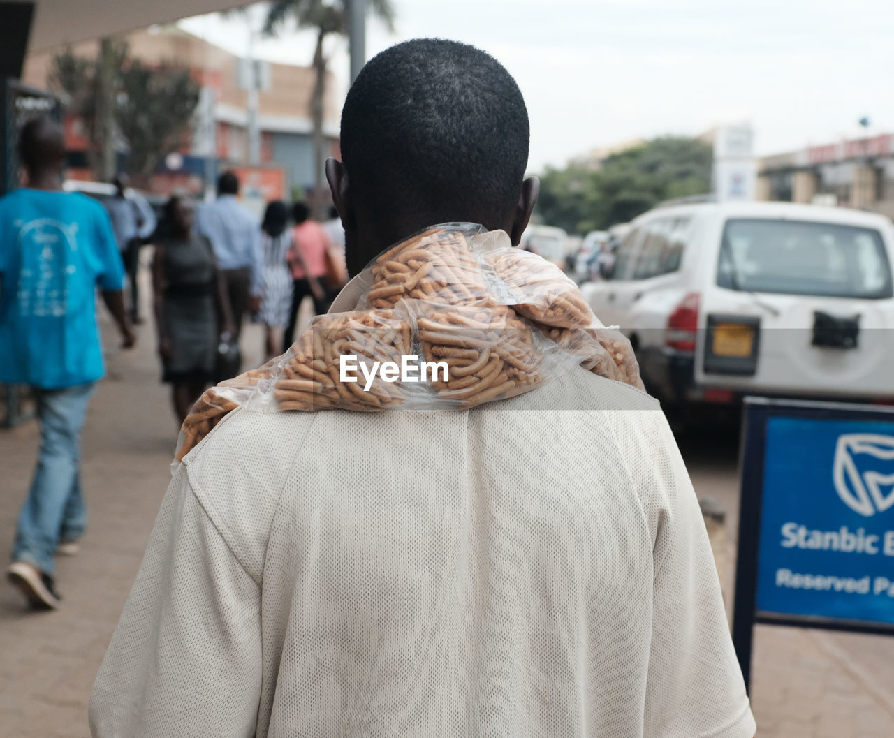 REAR VIEW OF COUPLE STANDING ON STREET