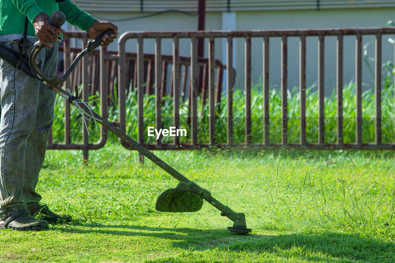 MAN WITH ARMS OUTSTRETCHED IN LAWN