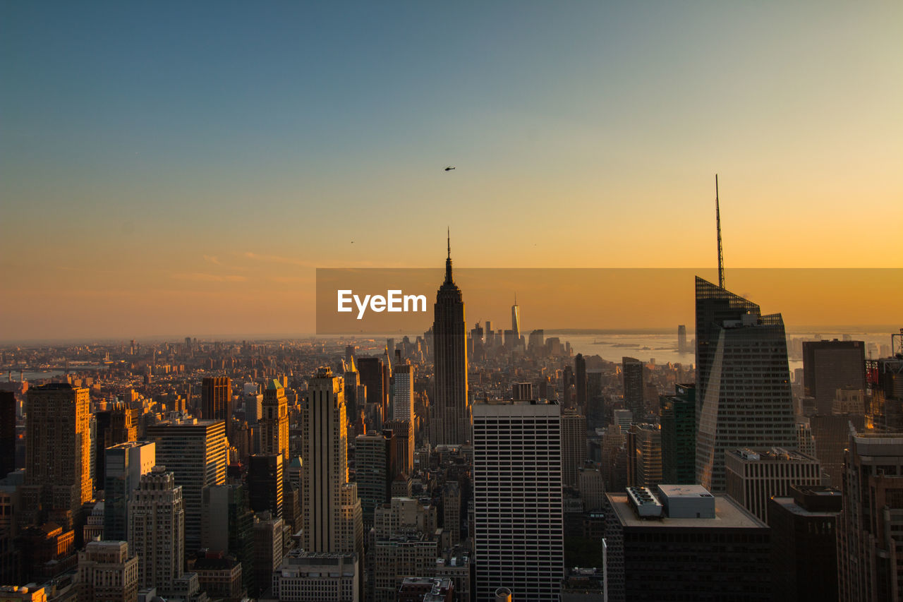 Cityscape against sky at sunset