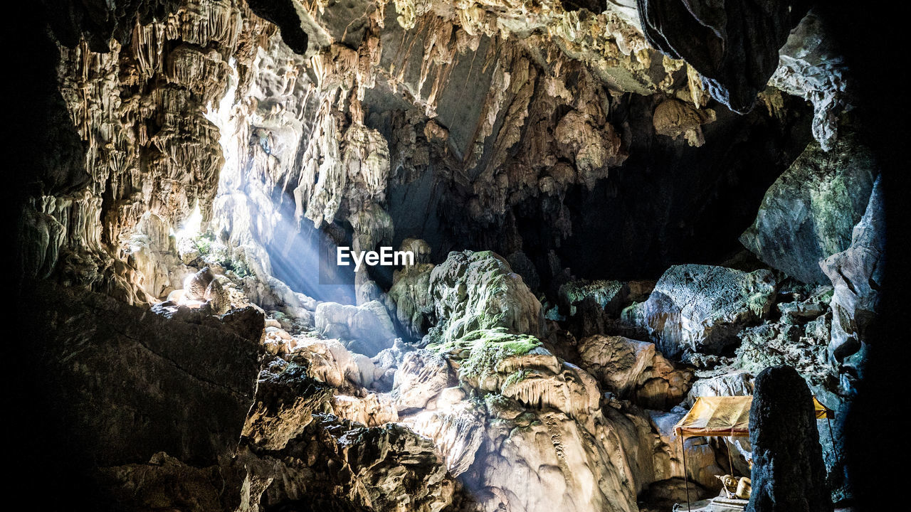 Sunlight streaming through rocks in cave