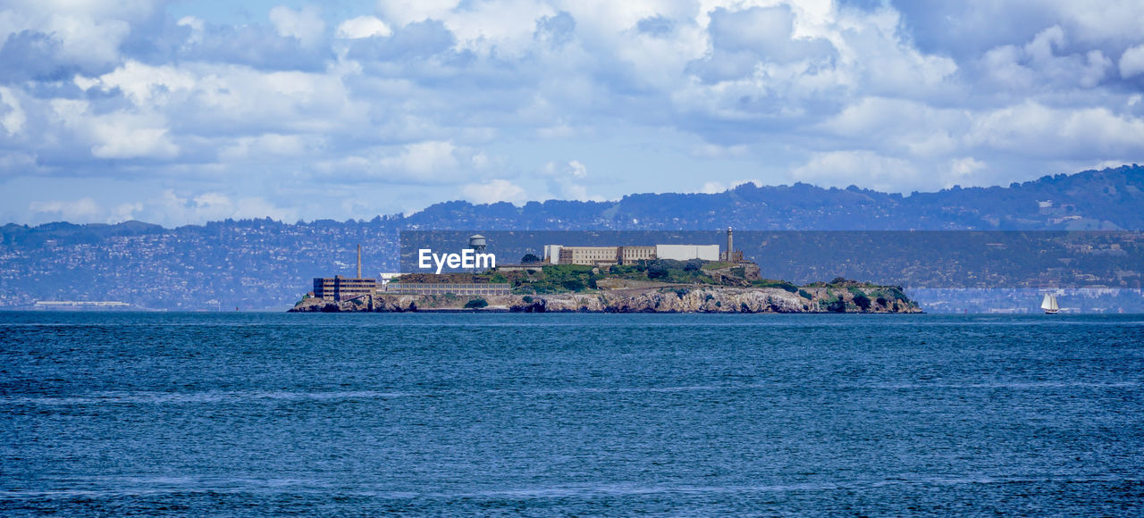 SCENIC VIEW OF SEA AGAINST BUILDINGS