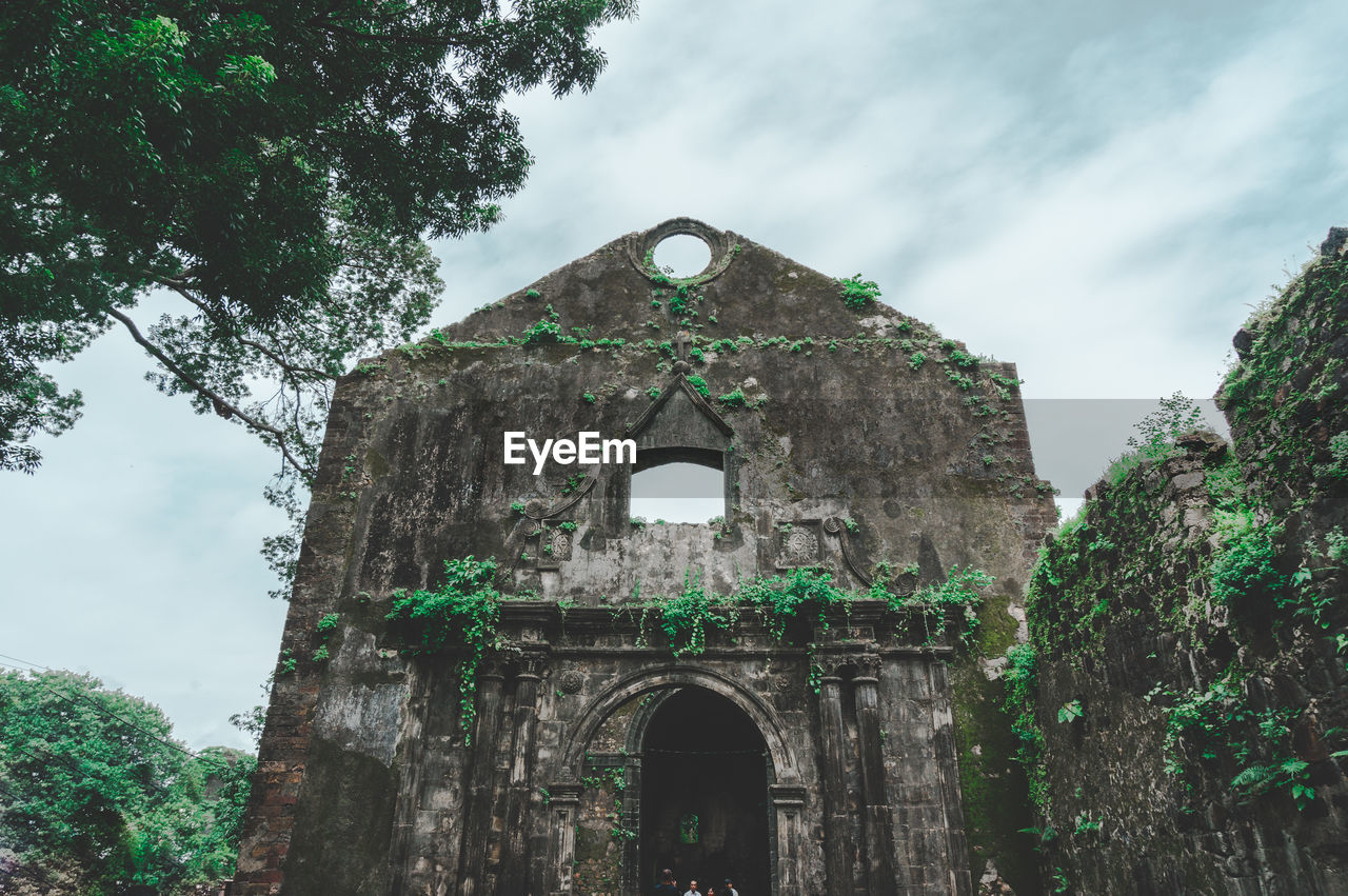 Low angle view of old abandoned fort against sky