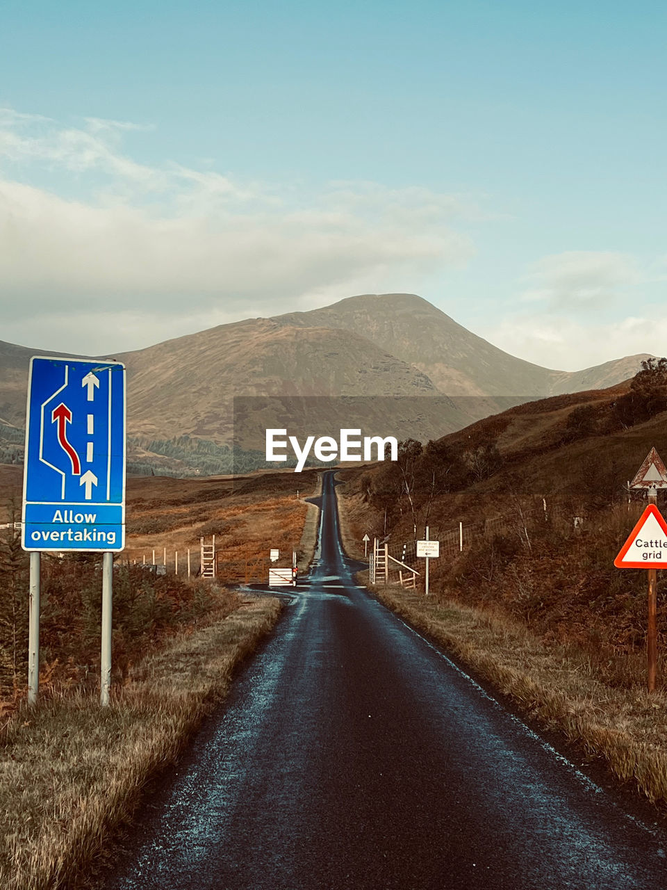 Road by mountain against sky