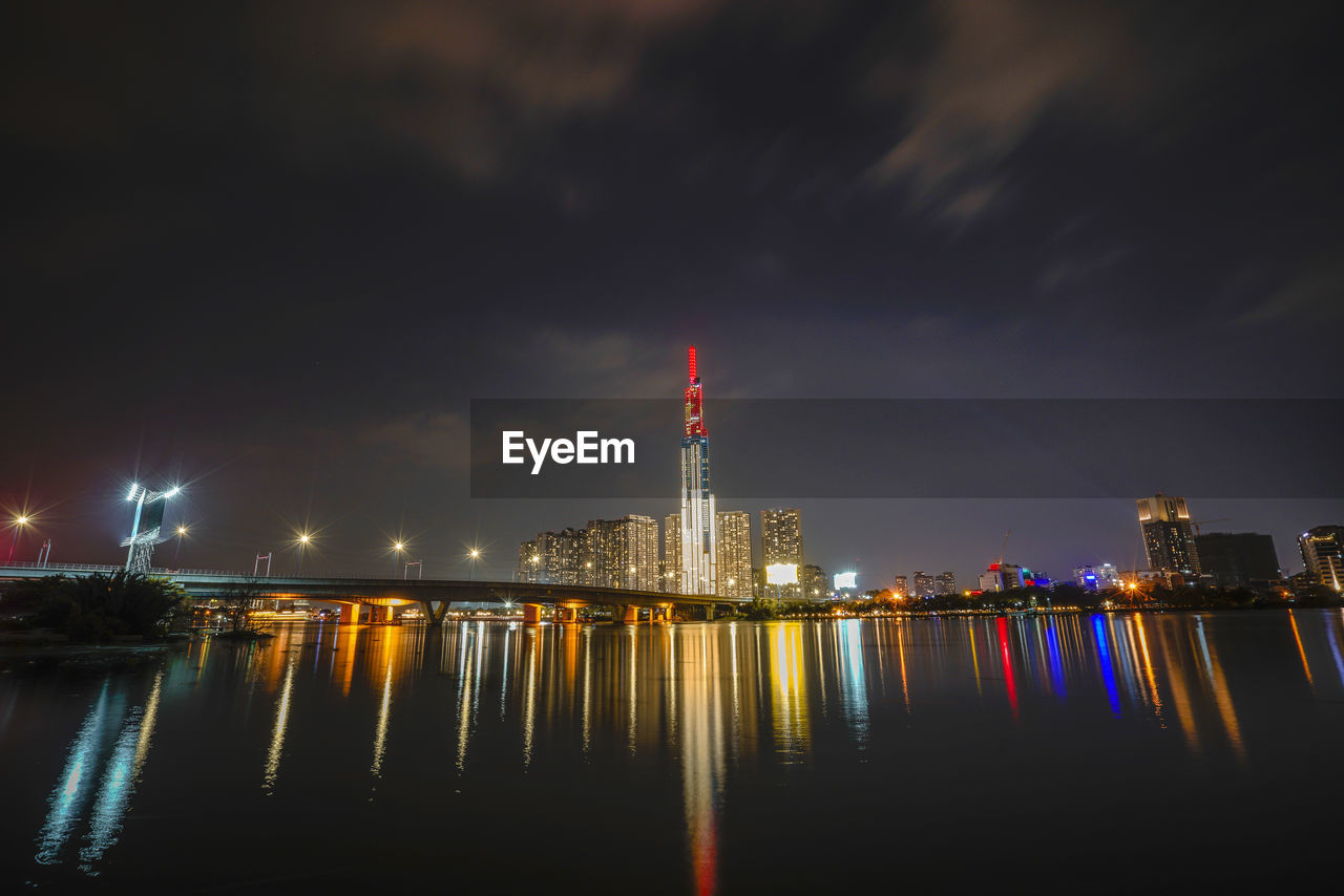 ILLUMINATED BUILDINGS AT WATERFRONT