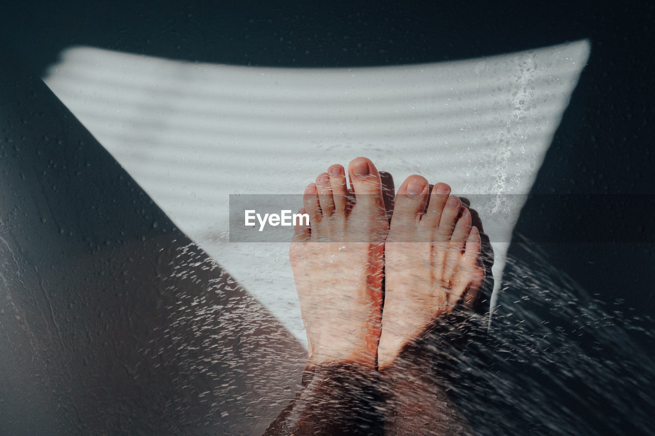 High angle view of water splashing over legs