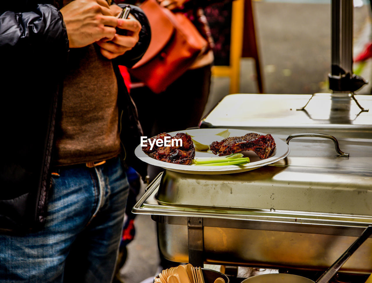 Midsection of man holding food