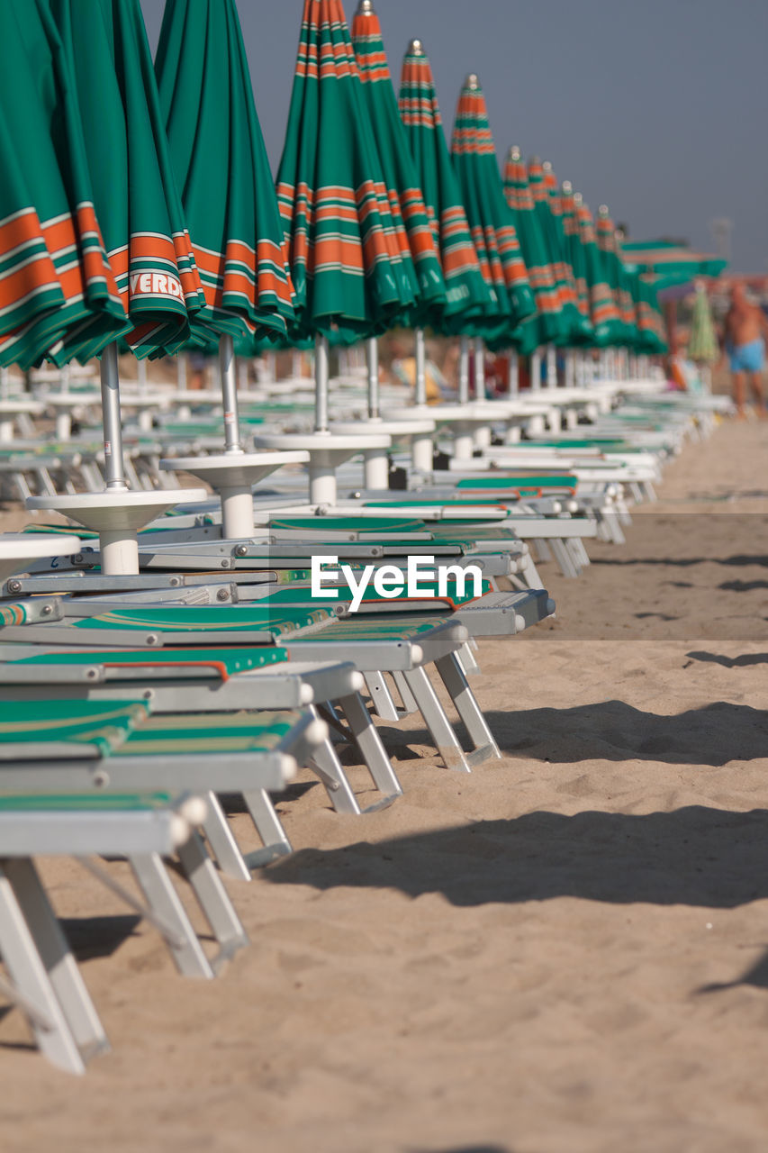 Deck chairs with parasols at beach
