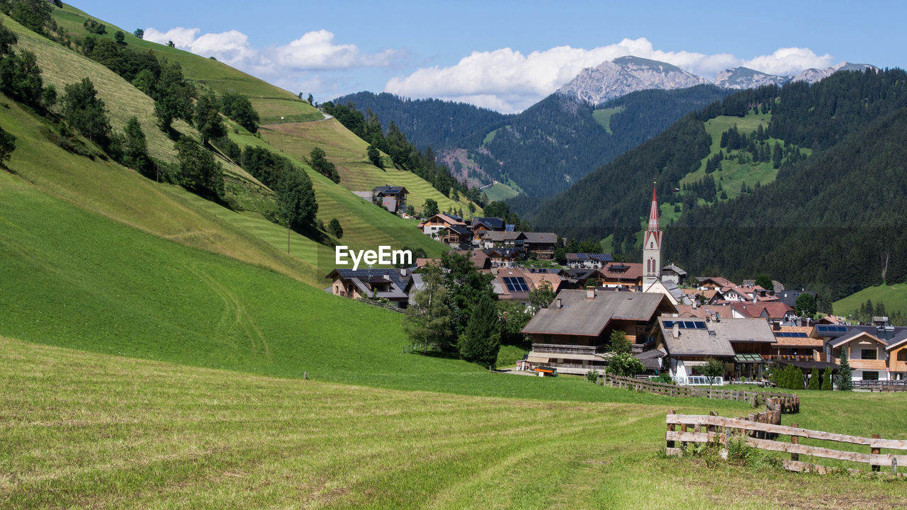 SCENIC VIEW OF GREEN LANDSCAPE AND MOUNTAINS