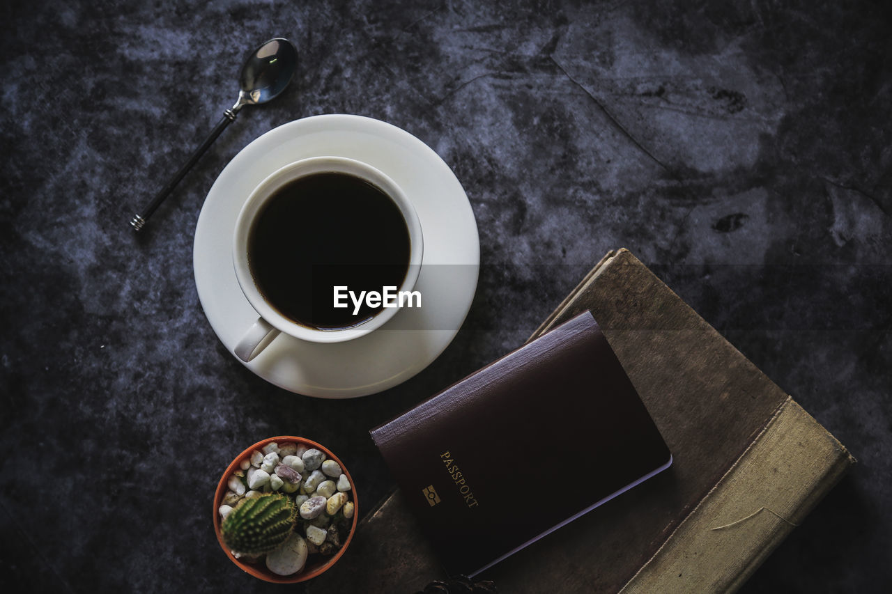 HIGH ANGLE VIEW OF BLACK COFFEE AND CUP ON TABLE