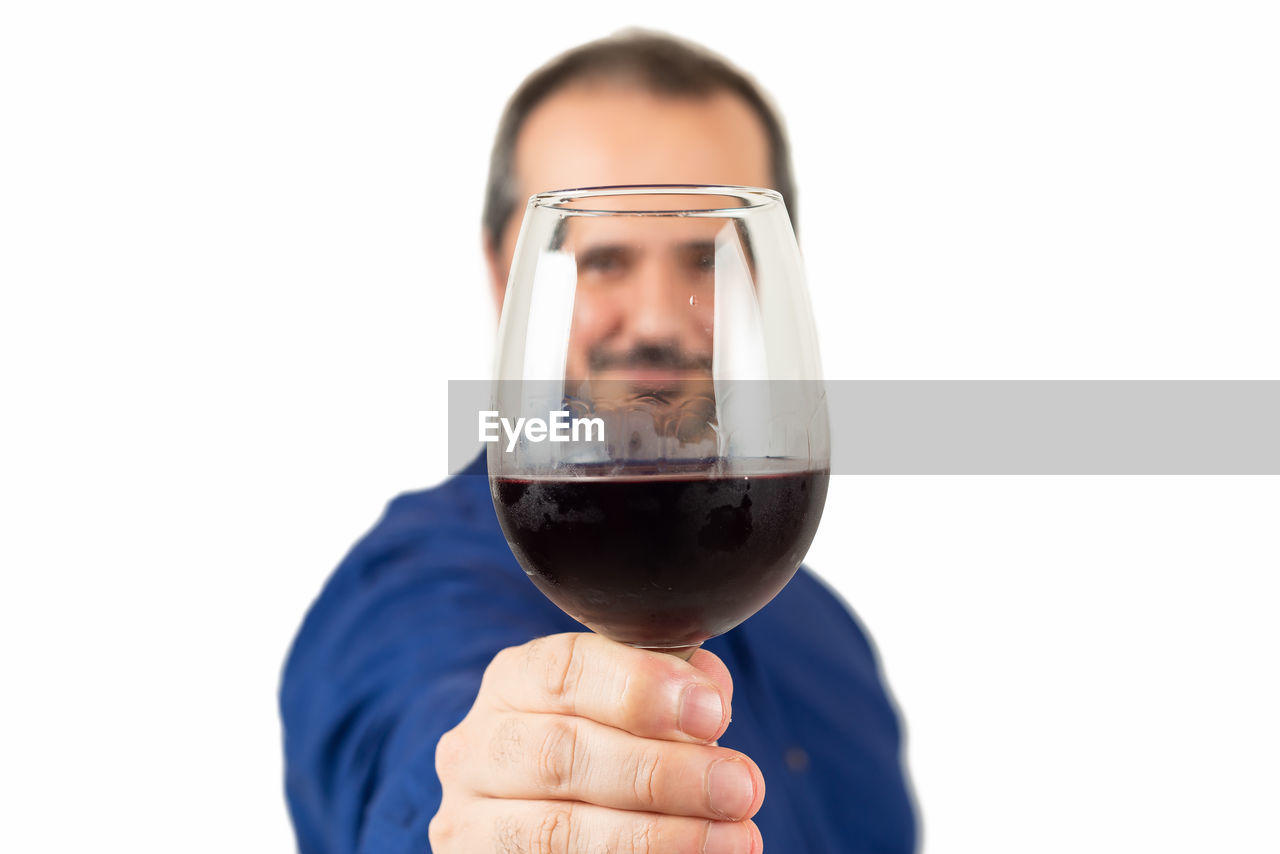 PORTRAIT OF MAN HOLDING GLASS OF WHITE BACKGROUND