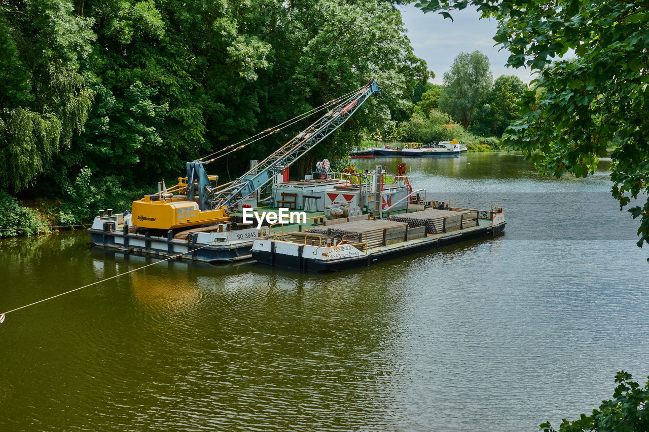 BOATS SAILING IN RIVER