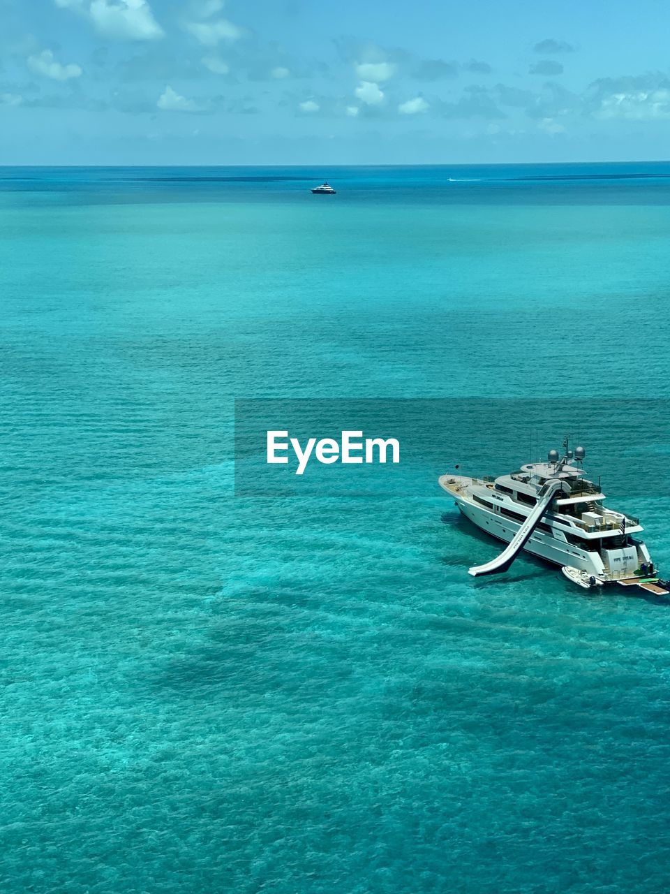 BOAT IN SEA AGAINST SKY