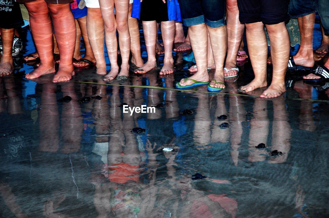 Low section of people standing in water