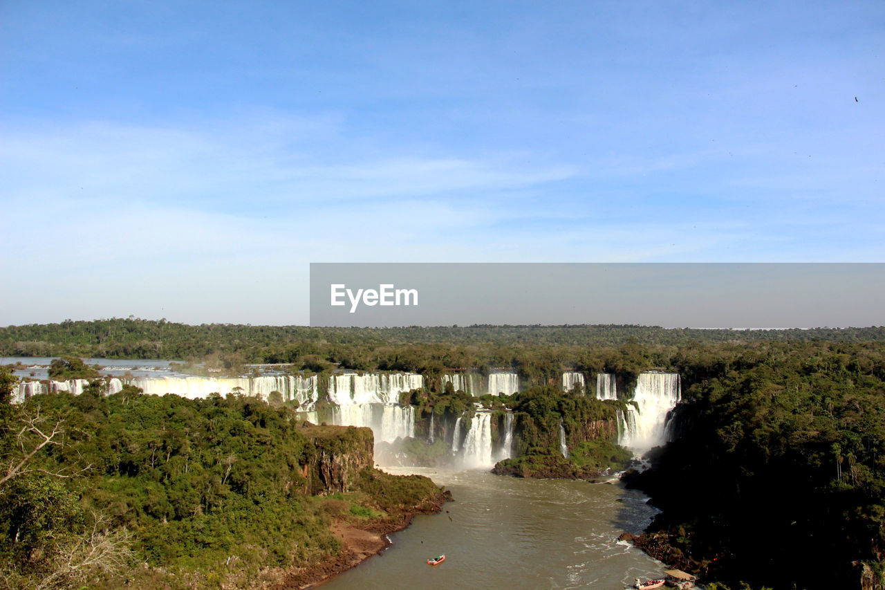 Scenic view of waterfall against sky