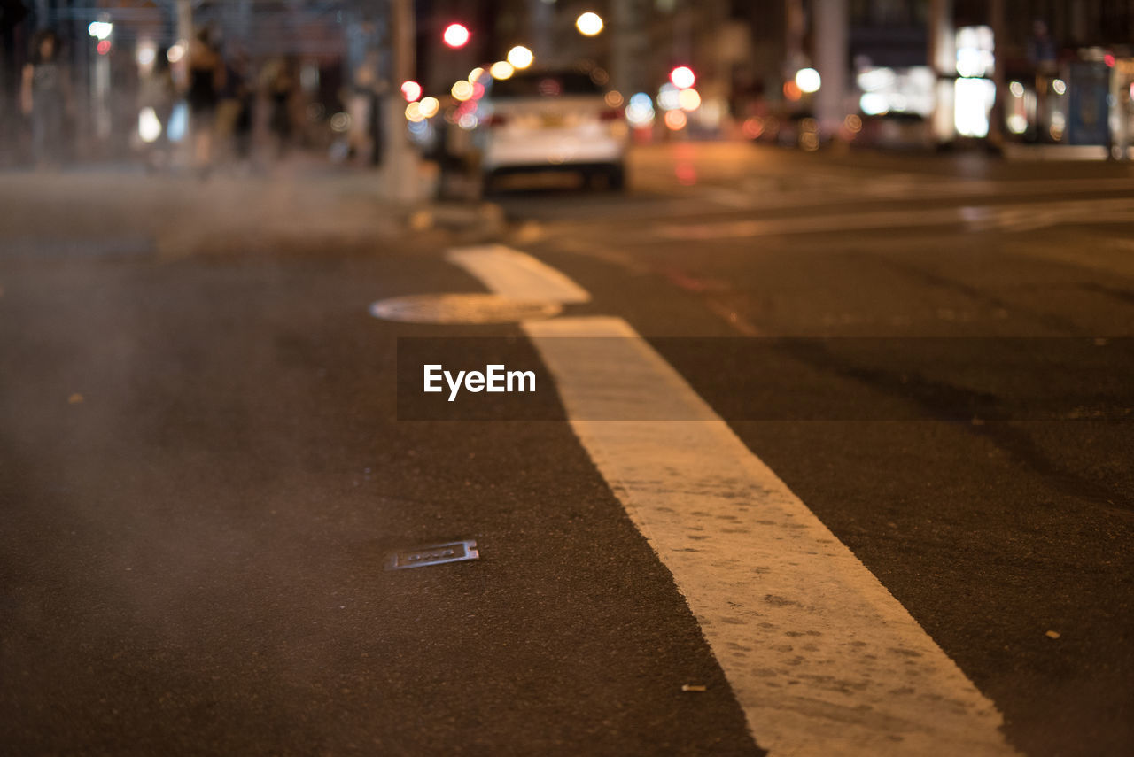 Car on illuminated street at night