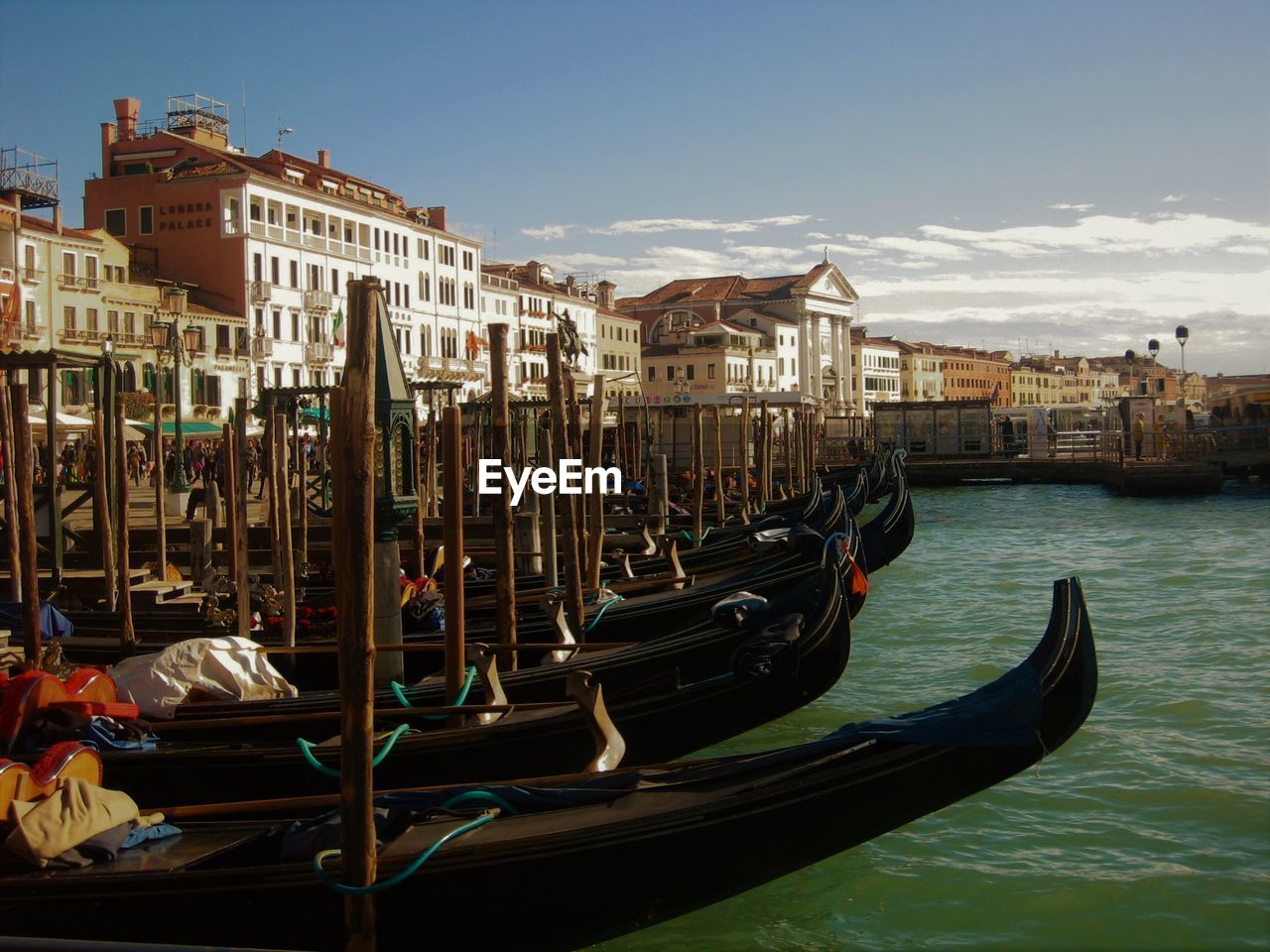 Gondolas moored on grand canal in city